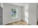 Bright room with wood floor and a window offering natural light and a pleasant outdoor view at 11073 Jackdaw Rd, Weeki Wachee, FL 34614