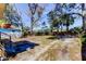 Large, empty backyard with a view of the surrounding trees at 1208 E Giddens Ave, Tampa, FL 33603
