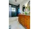 Updated bathroom boasting stylish tile, modern fixtures, and wood vanity at 1208 E Giddens Ave, Tampa, FL 33603