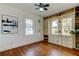 Cozy bedroom with white walls, a ceiling fan, hardwood floors, and built-in shelving at 1208 E Giddens Ave, Tampa, FL 33603