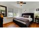 Inviting bedroom with plush bedding, natural light, and hardwood floors at 1208 E Giddens Ave, Tampa, FL 33603