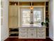 Bright bedroom featuring built-in shelving, hardwood floors, and natural light at 1208 E Giddens Ave, Tampa, FL 33603
