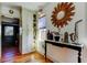 Bright entryway featuring wood floors and a charming console table with decorative mirror at 1208 E Giddens Ave, Tampa, FL 33603