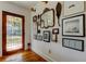 Stylish entryway featuring hardwood floors and curated wall decor at 1208 E Giddens Ave, Tampa, FL 33603