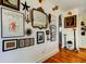 Stylish hallway adorned with an eclectic art collection and wooden floors at 1208 E Giddens Ave, Tampa, FL 33603