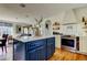 Bright kitchen features a blue island, stainless steel oven, and open shelving at 1208 E Giddens Ave, Tampa, FL 33603