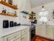 Kitchen with stainless steel appliances, white marble countertops, and open shelving at 1208 E Giddens Ave, Tampa, FL 33603