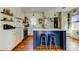 Charming eat-in kitchen featuring a center island with bar seating and hardwood floors at 1208 E Giddens Ave, Tampa, FL 33603