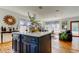 Open kitchen with a large center island, white countertops and view to the living room at 1208 E Giddens Ave, Tampa, FL 33603