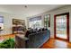 Comfortable living room featuring hardwood floors, a large window, and elegant furnishings at 1208 E Giddens Ave, Tampa, FL 33603