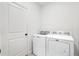 Laundry room with a white washer and dryer at 12630 Aston Dr, Hudson, FL 34669