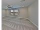 Bedroom featuring two windows, ceiling fan, and neutral carpeting at 12779 Fisherville Way, Riverview, FL 33579