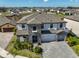 Stunning two-story home with stone accents, well-manicured landscaping, and a paved driveway at 12779 Fisherville Way, Riverview, FL 33579