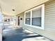 Inviting front porch with gray flooring and siding, offering a cozy outdoor space at 1312 E 19Th Ave, Tampa, FL 33605