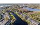 Waterfront townhomes nestled beside a tranquil lake, surrounded by lush trees and greenery, a serene community at 13733 Juniper Blossom Dr, Tampa, FL 33618