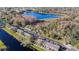 Beautiful townhome community on a lake, with parking areas and water views surrounded by trees and grass at 13733 Juniper Blossom Dr, Tampa, FL 33618