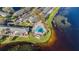 Scenic lakeside community with a swimming pool, parking areas, and well-maintained townhomes along the waterfront at 13733 Juniper Blossom Dr, Tampa, FL 33618