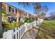 Brick townhome featuring a fenced backyard and patio with table and chairs at 13733 Juniper Blossom Dr, Tampa, FL 33618