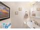 Small powder room featuring vanity with white sink, framed artwork, and decorative seashell accents at 13733 Juniper Blossom Dr, Tampa, FL 33618