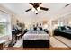 Spacious bedroom with wood floors, ceiling fan, storage bed, vanity, and closet with mirrored doors at 13733 Juniper Blossom Dr, Tampa, FL 33618
