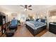 Large bedroom with wood floors, a ceiling fan, a storage bed and a large window for natural light at 13733 Juniper Blossom Dr, Tampa, FL 33618