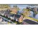 Charming brick townhomes nestled by a serene lake, complete with a parking area for residents and guests at 13733 Juniper Blossom Dr, Tampa, FL 33618