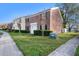 Brick townhome with a well-maintained lawn and landscaping in a suburban setting at 13733 Juniper Blossom Dr, Tampa, FL 33618