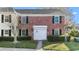 Charming two-story red brick townhome with neat landscaping and white doors and shutters at 13733 Juniper Blossom Dr, Tampa, FL 33618