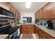 The brightly lit open kitchen features stainless steel appliances and granite countertops at 13733 Juniper Blossom Dr, Tampa, FL 33618