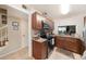 Well-lit kitchen features stainless steel appliances, brown cabinets, and granite countertops at 13733 Juniper Blossom Dr, Tampa, FL 33618