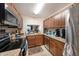 The open kitchen features stainless steel appliances and granite countertops, as well as modern lighting at 13733 Juniper Blossom Dr, Tampa, FL 33618