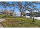 Scenic lake view with lush grass, trees, and reflections of buildings on a sunny day at 13733 Juniper Blossom Dr, Tampa, FL 33618