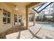 Outdoor living area with a screened-in lanai and pool at 13831 Rudi Loop, Spring Hill, FL 34609