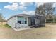 A covered, screened patio, outdoor seating, with a paver patio, and lawn at 15519 Lily Wood Ln, Brooksville, FL 34604