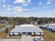 Expansive aerial view of the property, highlighting the roof, driveway, and surrounding foliage at 23227 Club Villas Dr # 38, Land O Lakes, FL 34639