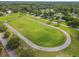 Aerial view of large community green space with neighborhood and surrounding trees at 23227 Club Villas Dr # 38, Land O Lakes, FL 34639