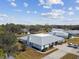 Wide aerial shot of the property displaying the roof, surrounding landscape, and neighborhood at 23227 Club Villas Dr # 38, Land O Lakes, FL 34639