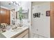 Bathroom vanity with double mirrors that create an airy feel, and a decorative plant adding a touch of nature at 23227 Club Villas Dr # 38, Land O Lakes, FL 34639
