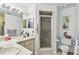 Well-lit bathroom featuring double sinks, a walk-in shower, and modern fixtures at 23227 Club Villas Dr # 38, Land O Lakes, FL 34639