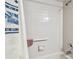 Well-maintained bathroom featuring tiled walls and a shower with accessible grab bar for added safety at 23227 Club Villas Dr # 38, Land O Lakes, FL 34639
