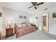 Comfortable bedroom with a classic daybed, ambient lighting, and a glimpse into the en-suite tiled bathroom at 23227 Club Villas Dr # 38, Land O Lakes, FL 34639