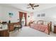 Cozy bedroom with a ceiling fan, a charming daybed, and a work area by the window for functionality at 23227 Club Villas Dr # 38, Land O Lakes, FL 34639