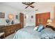 Comfortable bedroom with ceiling fan, plush carpet, and well-organized closet at 23227 Club Villas Dr # 38, Land O Lakes, FL 34639
