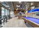 Inviting billiard room featuring pool tables, bar seating, and ample lighting at 23227 Club Villas Dr # 38, Land O Lakes, FL 34639