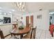 Bright dining area features tile floors and an elegant chandelier above a round wood table at 23227 Club Villas Dr # 38, Land O Lakes, FL 34639