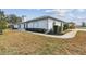 Charming exterior view of a well-maintained home with unique architectural details and manicured landscaping at 23227 Club Villas Dr # 38, Land O Lakes, FL 34639