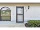 Close-up of a front door showing the address with well-maintained window and manicured bush at 23227 Club Villas Dr # 38, Land O Lakes, FL 34639