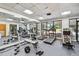 Community gym with workout equipment, mirrors, and a large window providing ample natural light at 23227 Club Villas Dr # 38, Land O Lakes, FL 34639