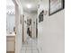 Hallway view features white tile floors and multiple doorways leading to various rooms throughout the home at 23227 Club Villas Dr # 38, Land O Lakes, FL 34639