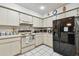 Functional kitchen features white cabinetry, essential appliances, and tile flooring at 23227 Club Villas Dr # 38, Land O Lakes, FL 34639